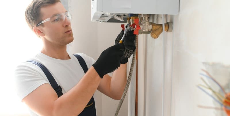 Plumber completing a hot water system replacement. 