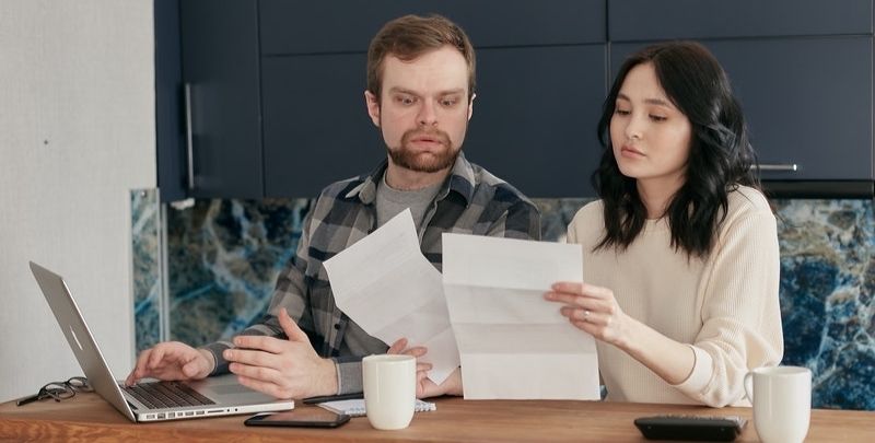 couple looking at expensive water bill