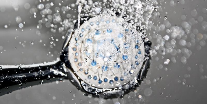 high pressure shower head with water on