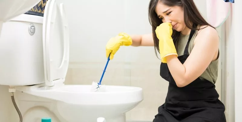 female fixing toilet