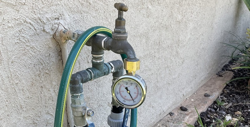 water pressure testing attachment on an outdoor garden tap